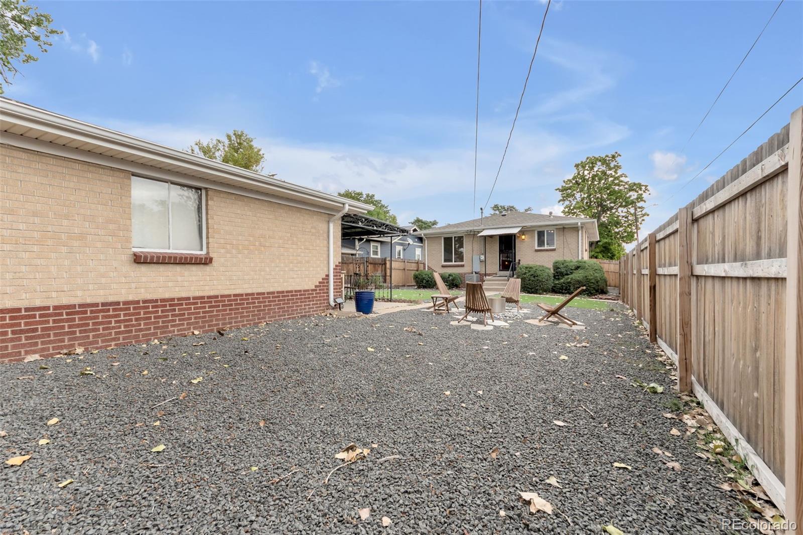 4901 Grove Street Denver, CO 80221 - Photo 20 of 25 a view of a house with a backyard