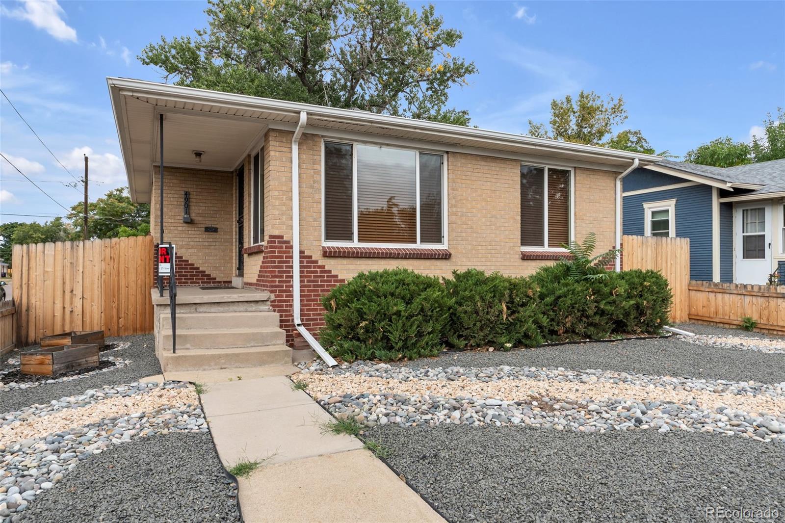 4901 Grove Street Denver, CO 80221 - Photo 3 of 25 a view of a house with a yard