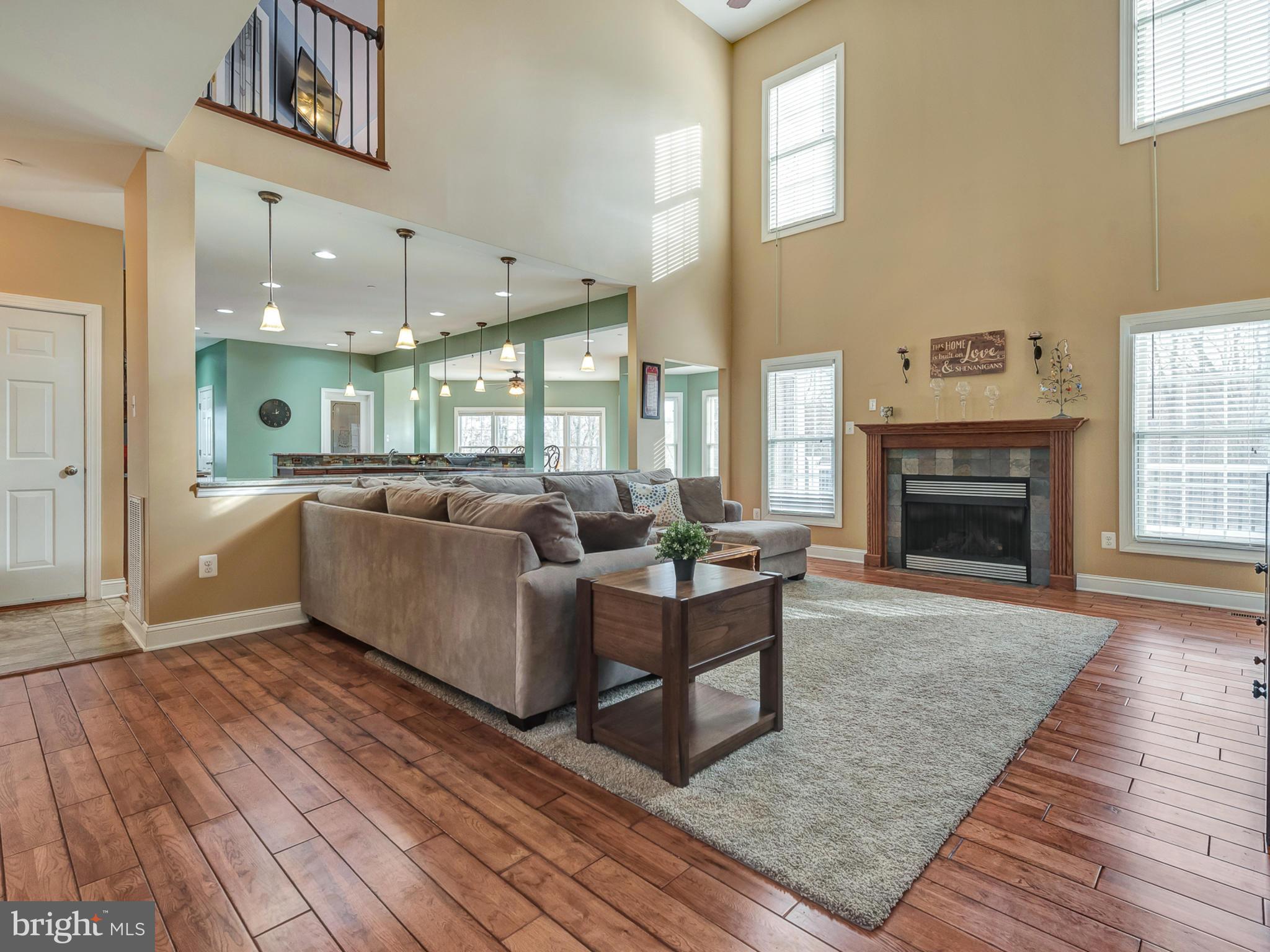 4947 Old Swimming Pool Road Frederick, MD 21703 - Photo 14 of 72 a living room with furniture wooden floor and a fireplace