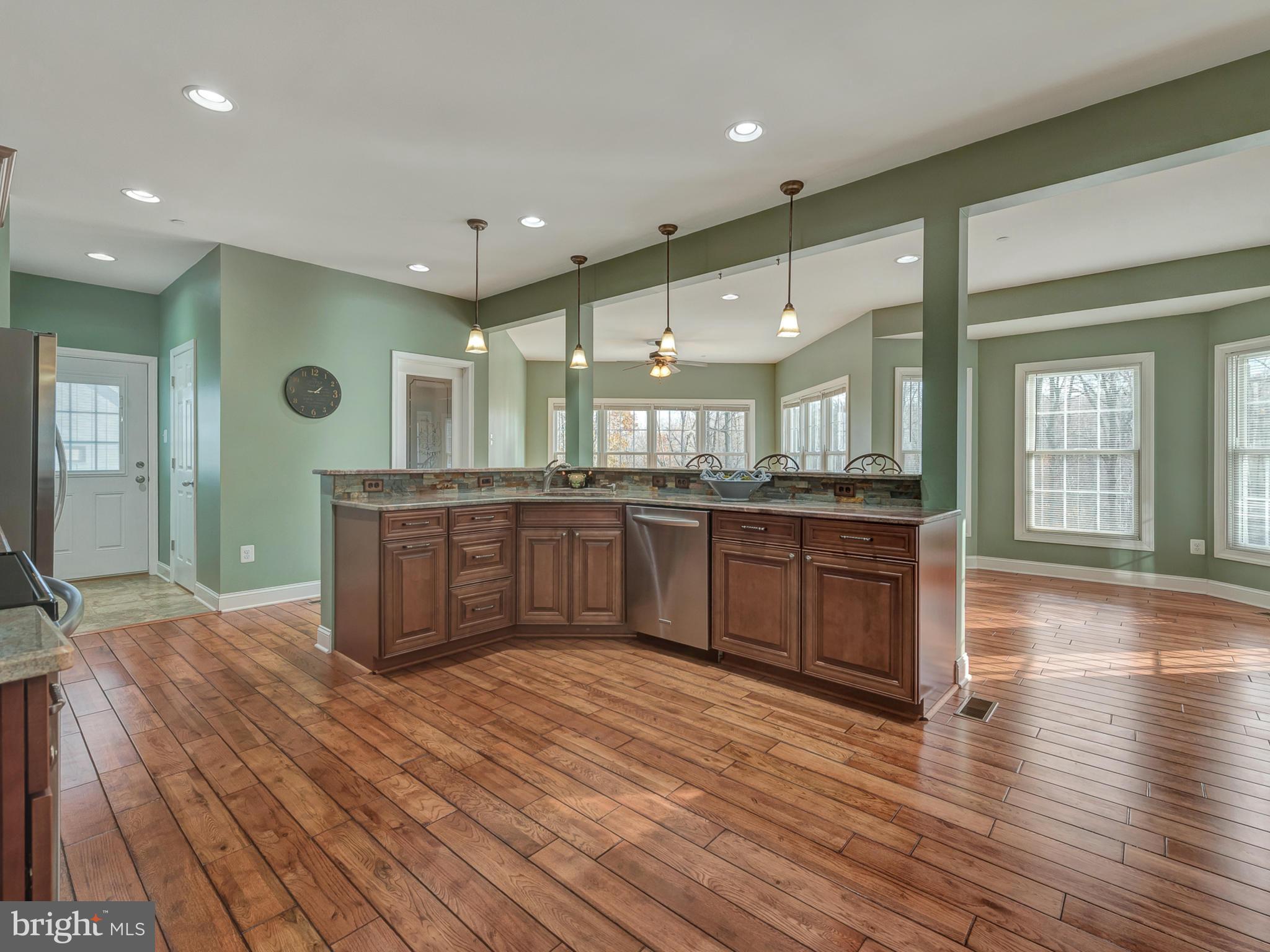 4947 Old Swimming Pool Road Frederick, MD 21703 - Photo 27 of 72 a large kitchen with stainless steel appliances granite countertop a large counter top a sink and a wooden floors