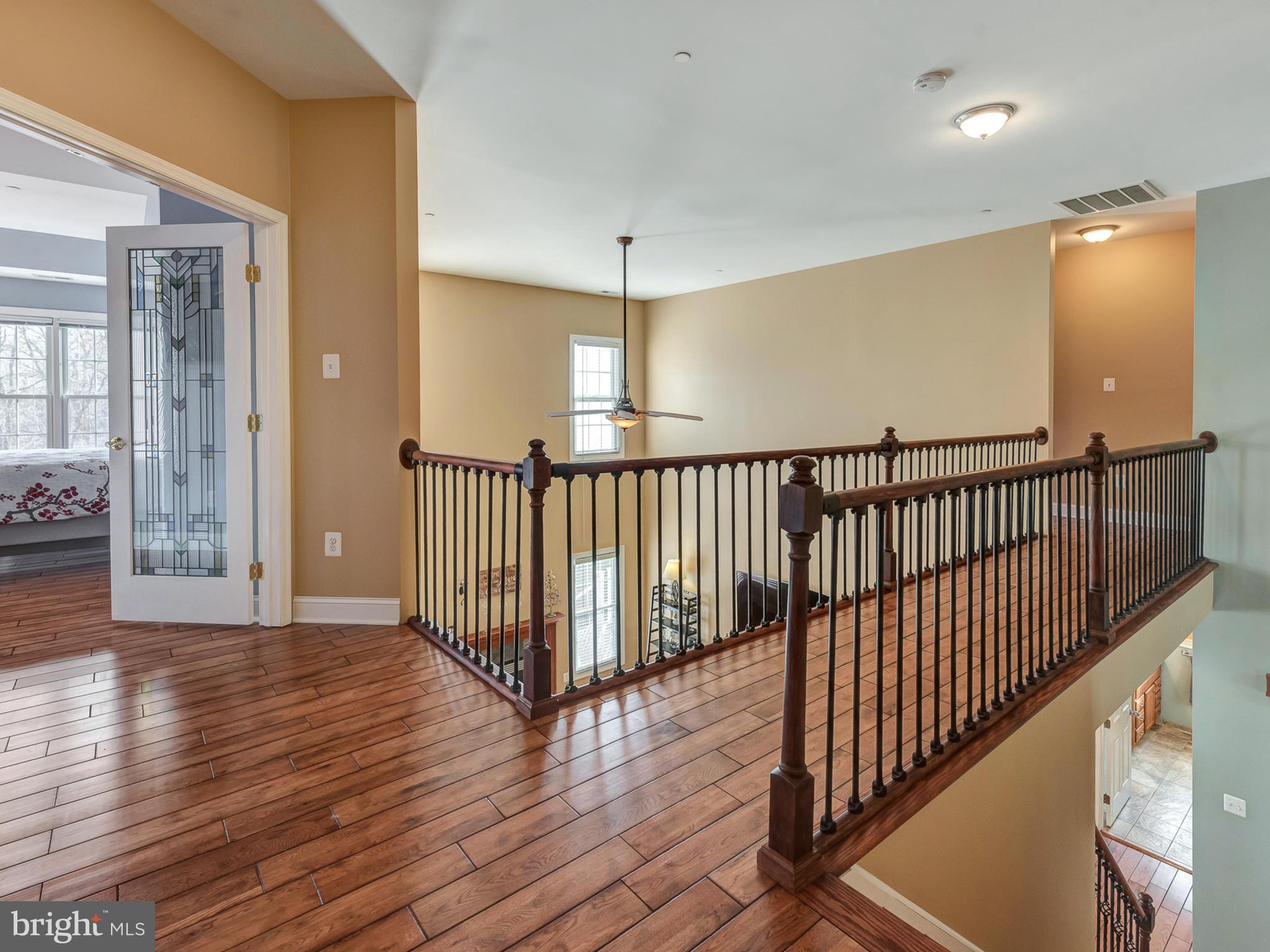 4947 Old Swimming Pool Road Frederick, MD 21703 - Photo 29 of 72 a view of a hallway with wooden floor and windows