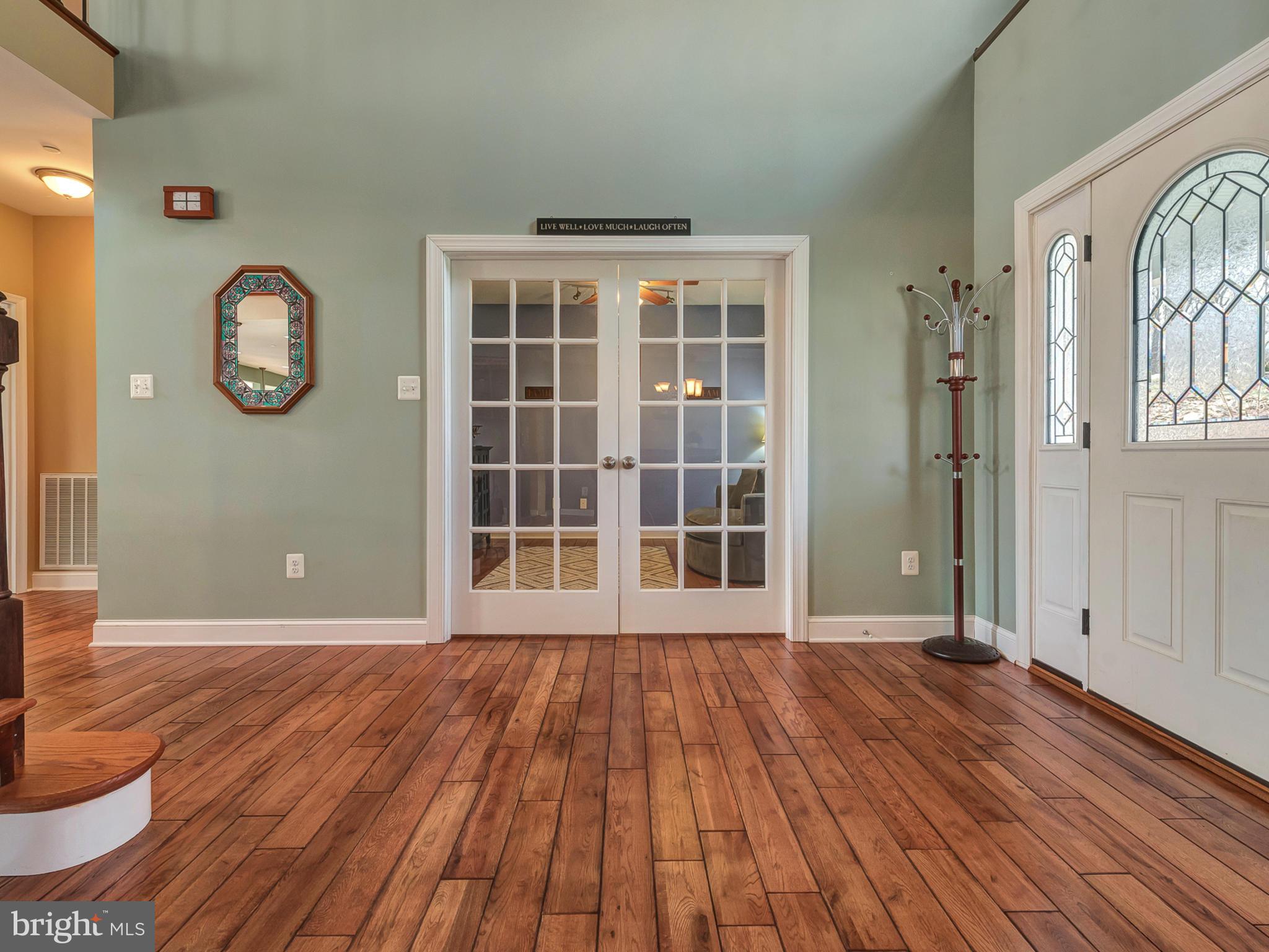 4947 Old Swimming Pool Road Frederick, MD 21703 - Photo 4 of 72 a view of empty room with wooden floor and windows