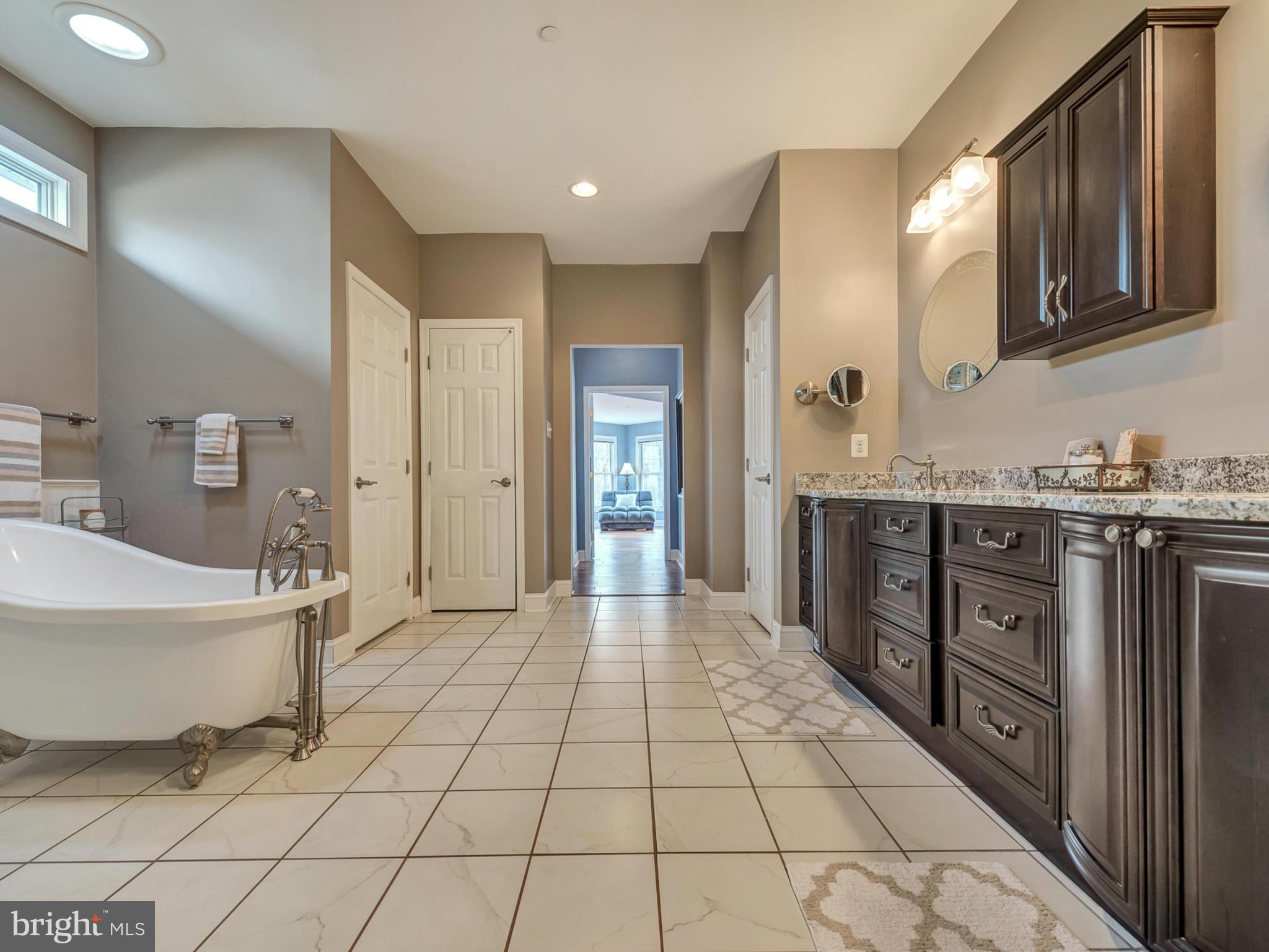 4947 Old Swimming Pool Road Frederick, MD 21703 - Photo 41 of 72 a spacious bathroom with a mirror and a bathtub