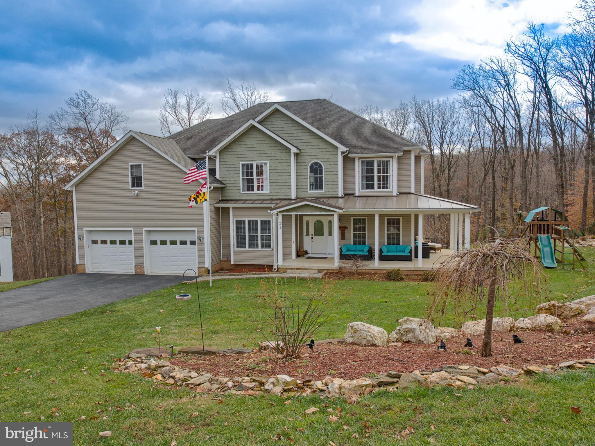 4947 Old Swimming Pool Road Frederick, MD 21703 - Photo 69 of 72 a front view of a house with a garden
