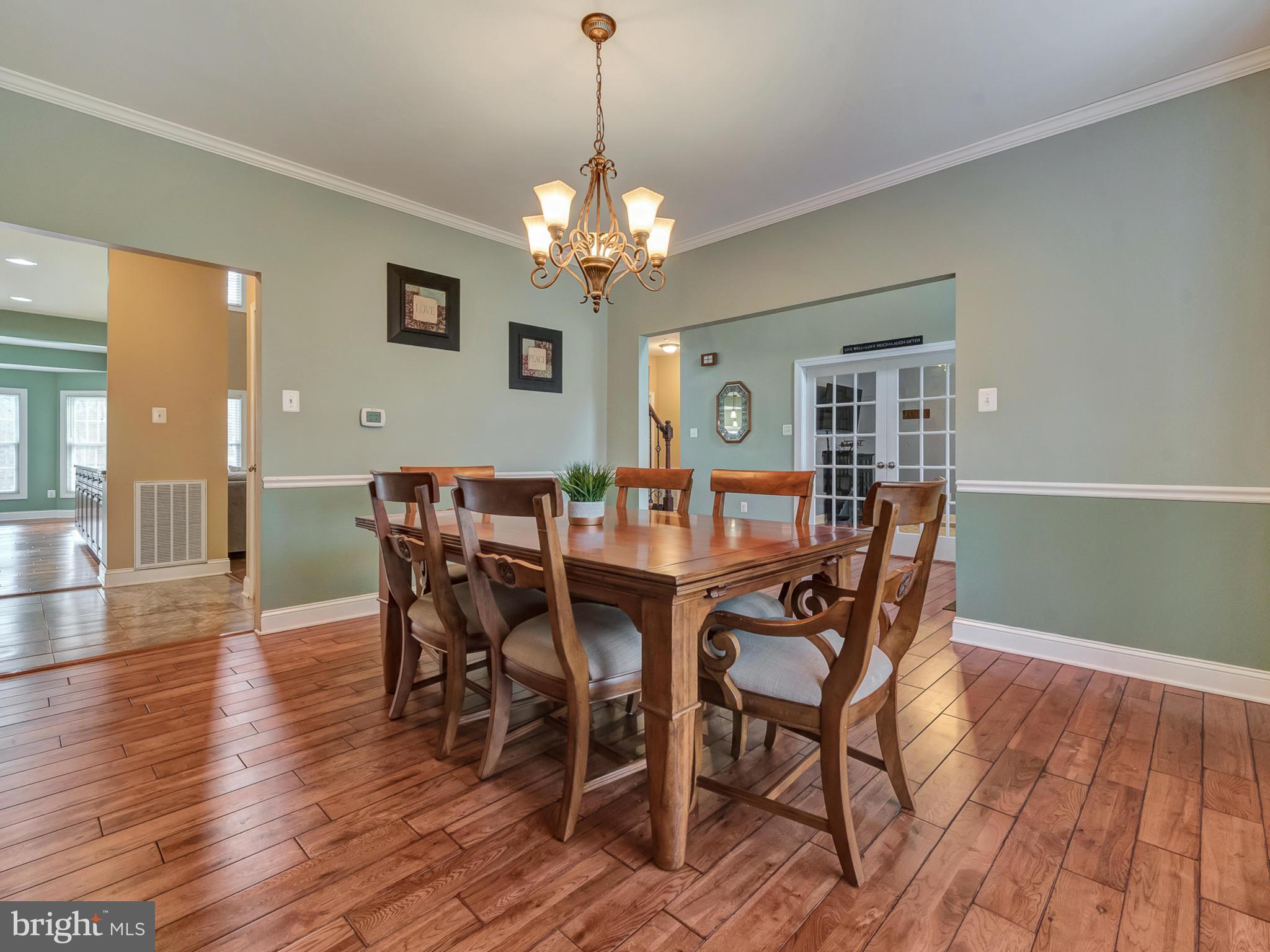 4947 Old Swimming Pool Road Frederick, MD 21703 - Photo 8 of 72 a view of a dining room with furniture wooden floor and chandelier