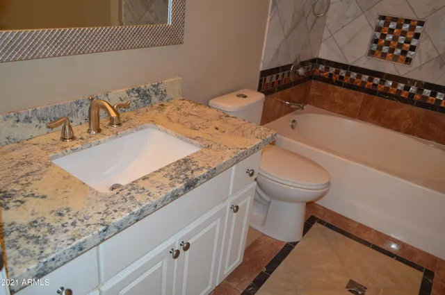 a bathroom with a shower and a sink