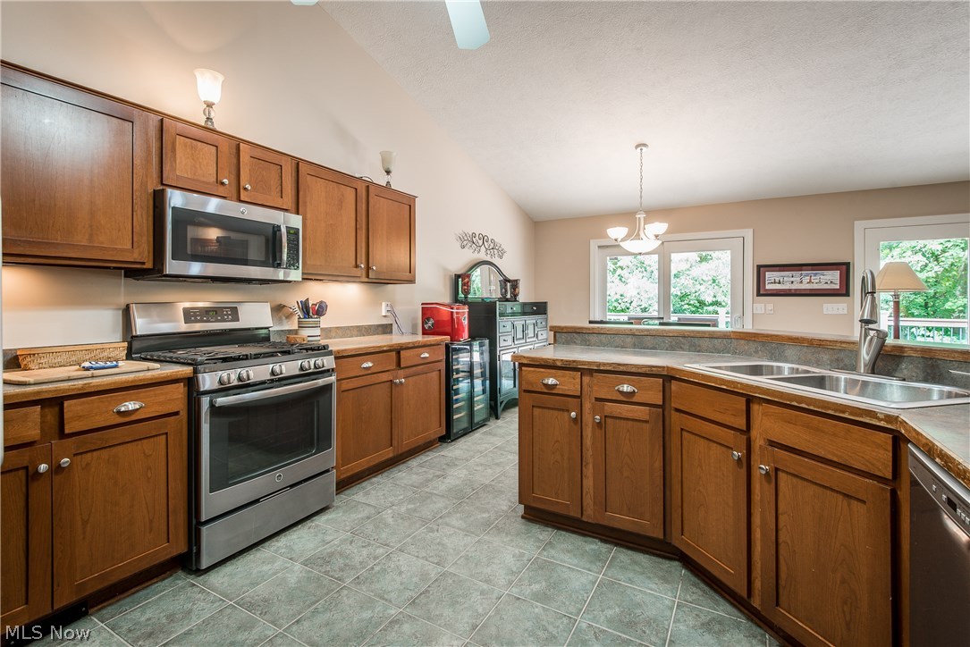 5382 Grove Road Clinton, OH 44216 - Photo 16 of 35 Cherry cabinetry and stainless steel appliances