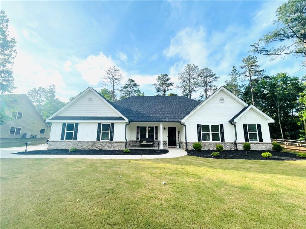 26 Courtland Road Jefferson, GA 30549 - Photo 1 of 1 a front view of a house with a yard table and chairs