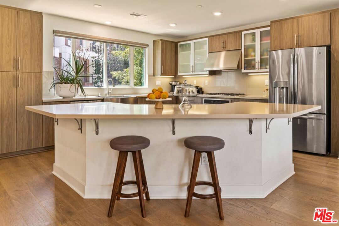 2776 Wright Lane Los Angeles, CA 90068 - Photo 8 of 16 a kitchen with stainless steel appliances a sink and a refrigerator