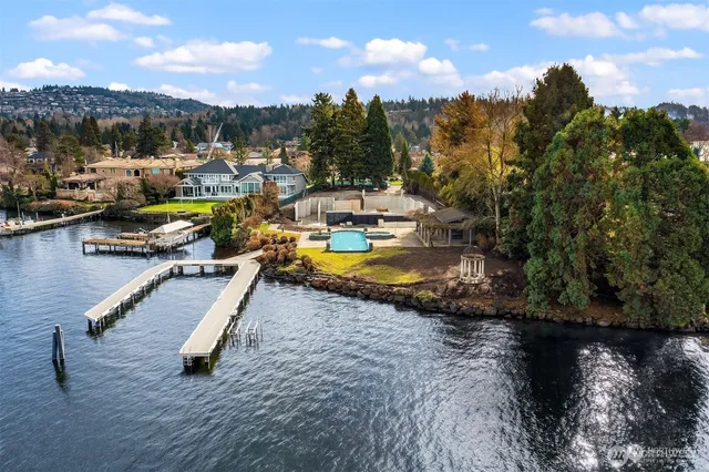 an aerial view of a house with a garden and lake view