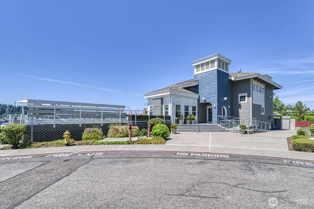 a front view of a house with a yard and potted plants