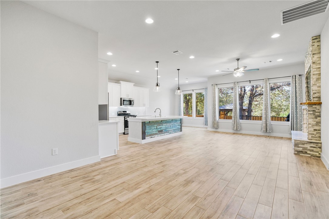 941 Del Raphael Drive Leander, TX 78641 - Photo 4 of 33 Wood-look tile floors are a total game changer for high traffic, running seamlessly through the common areas