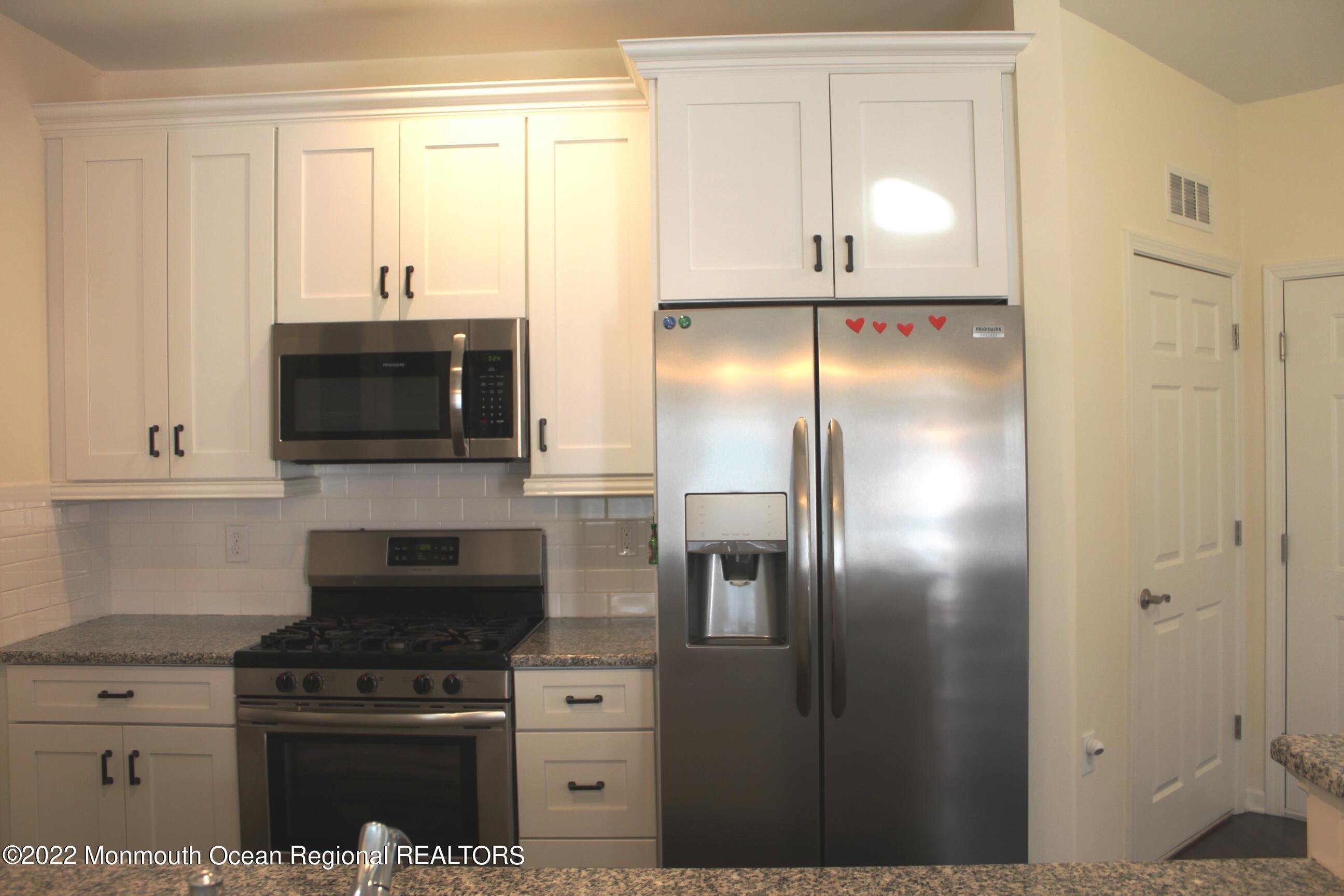 a kitchen with cabinets and stainless steel appliances