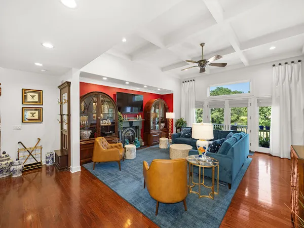 a living room with furniture kitchen view and a large window