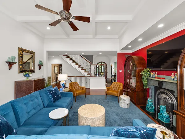 a living room with furniture a rug and white walls