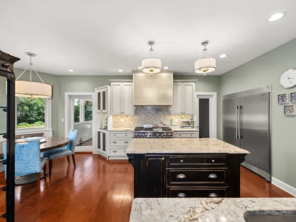 a kitchen with a stove a refrigerator and a fireplace