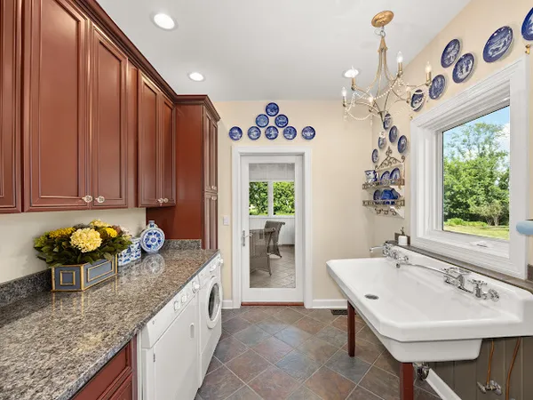 a kitchen with a sink cabinets and window