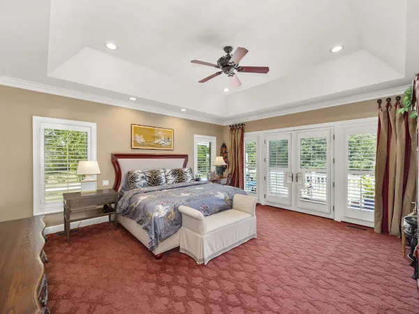 a spacious bedroom with a large bed and a large window