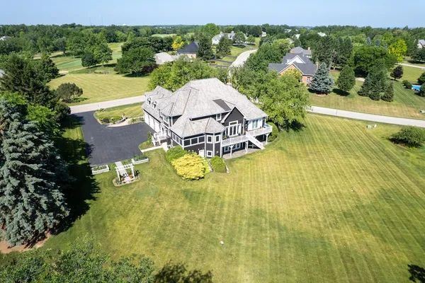 an aerial view of residential houses with outdoor space and swimming pool
