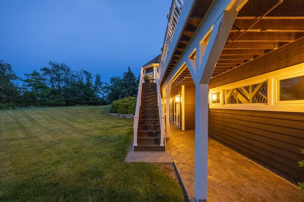 a view of a big building with a big yard and large trees