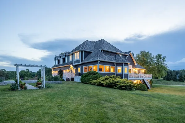 an aerial view of a house with swimming pool and big yard