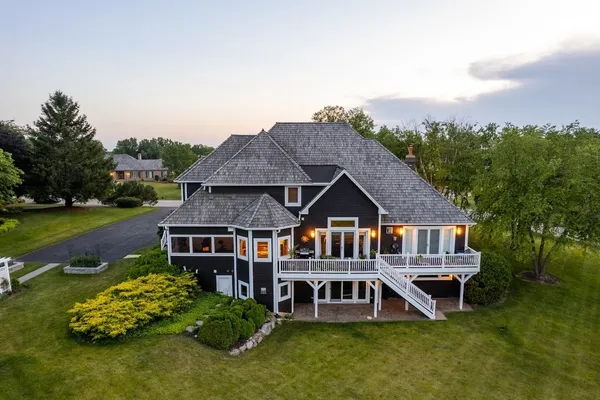 an aerial view of a house with pool outdoor seating and yard