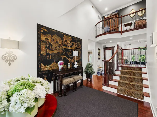 a living room filled with furniture and a potted plant