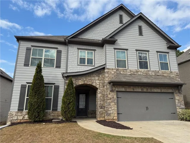 a front view of a house with yard