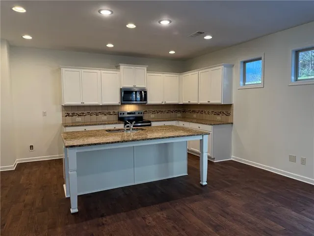 a view of kitchen with sink microwave and stove