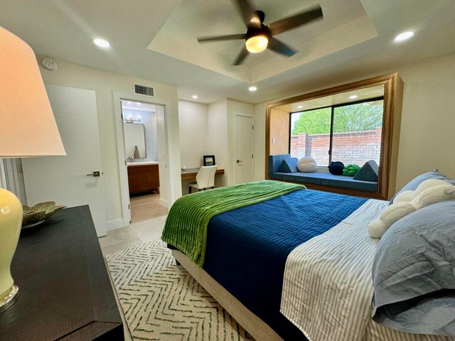 a bedroom with a bed and a lamp