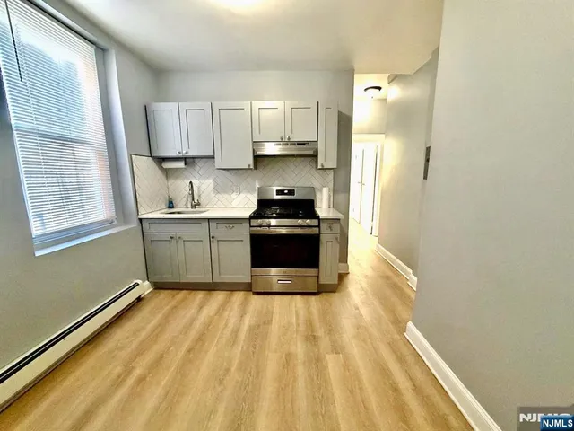 a kitchen with a stove and a white cabinet