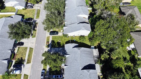 an aerial view of a house with a yard