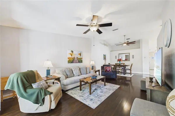 a living room with furniture and a wooden floor