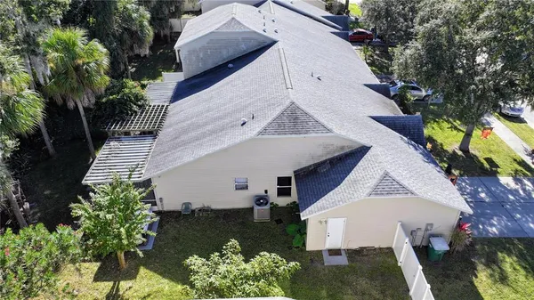 a aerial view of a house with yard and outdoor seating