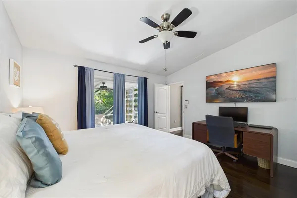 a view of a white house with a big yard and large trees