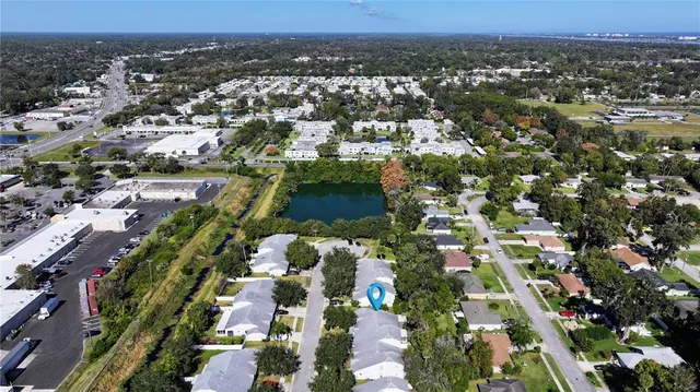 a living room with a floor to ceiling window and wooden floor
