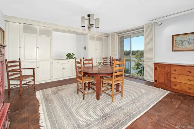 a dining room with furniture and wooden floor