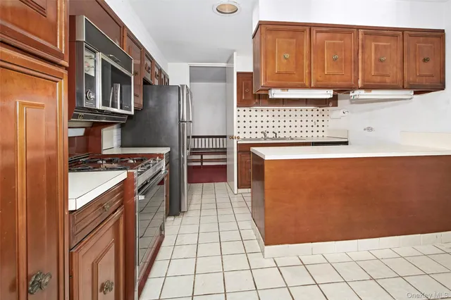 a kitchen with stainless steel appliances a stove a sink and a microwave