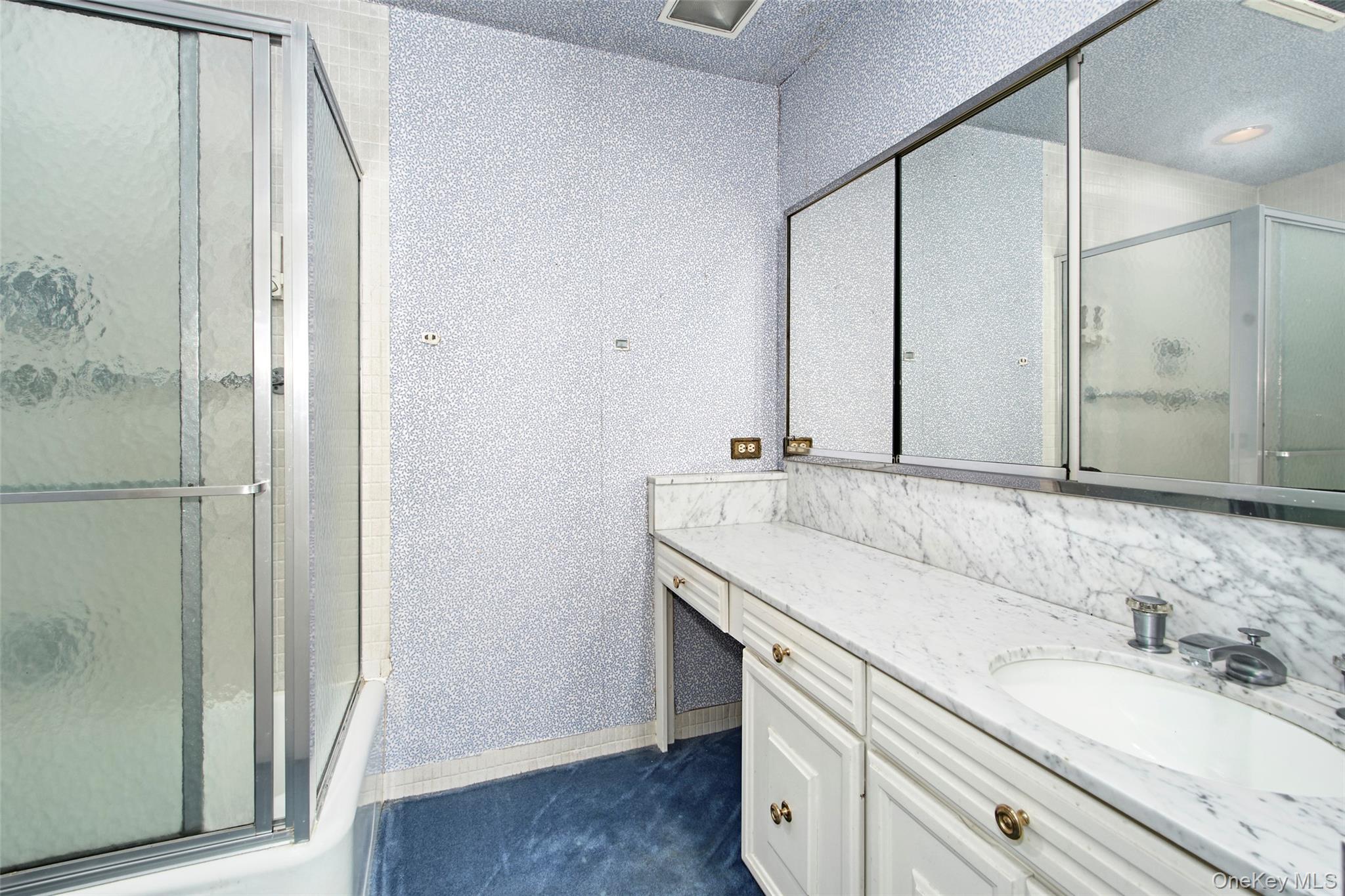 720 Milton Road, Unit 4C WEST Rye, NY 10580 - Photo 9 of 21 a bathroom with a granite countertop sink and a mirror