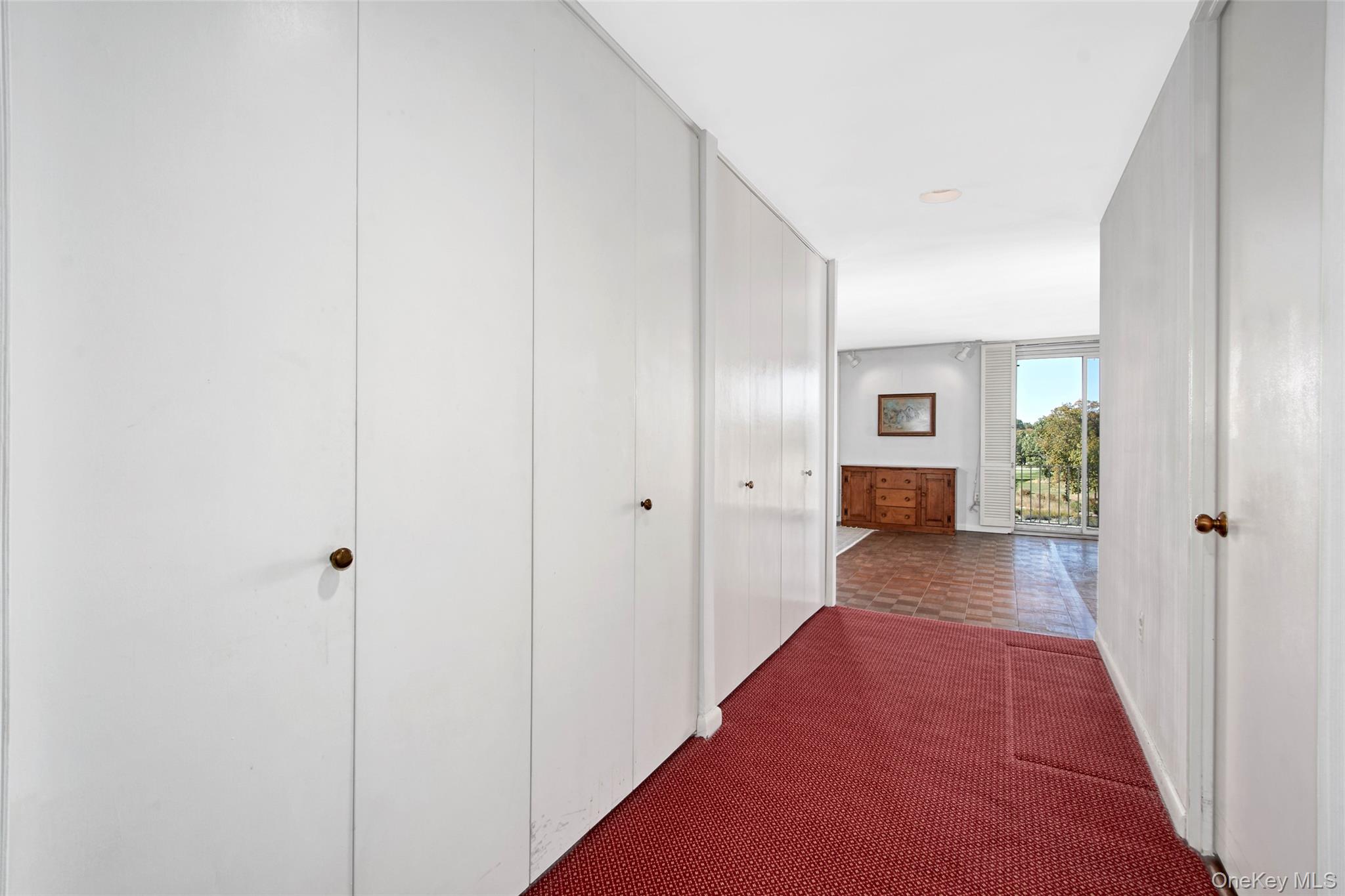 720 Milton Road, Unit 4C WEST Rye, NY 10580 - Photo 10 of 21 a view of a hallway with wooden floor and closet