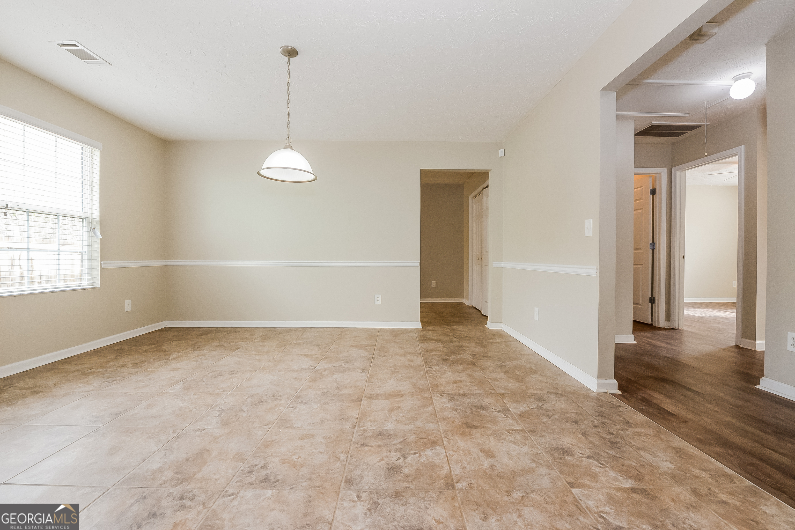 5179 Tew Lane Southwest Covington, GA 30014 - Photo 4 of 16 an empty room with windows and ceiling fan