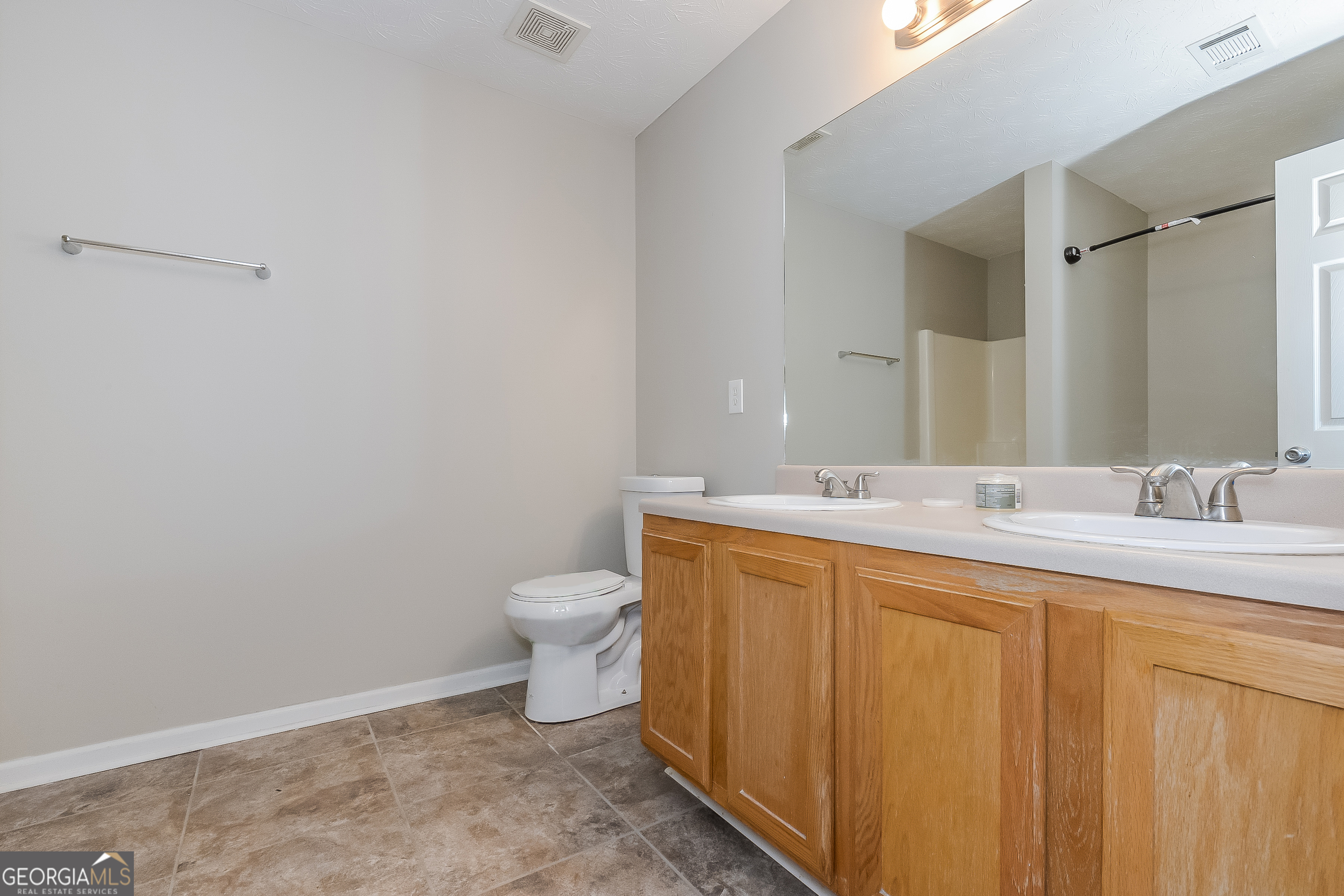 5179 Tew Lane Southwest Covington, GA 30014 - Photo 10 of 16 a bathroom with a sink and a toilet