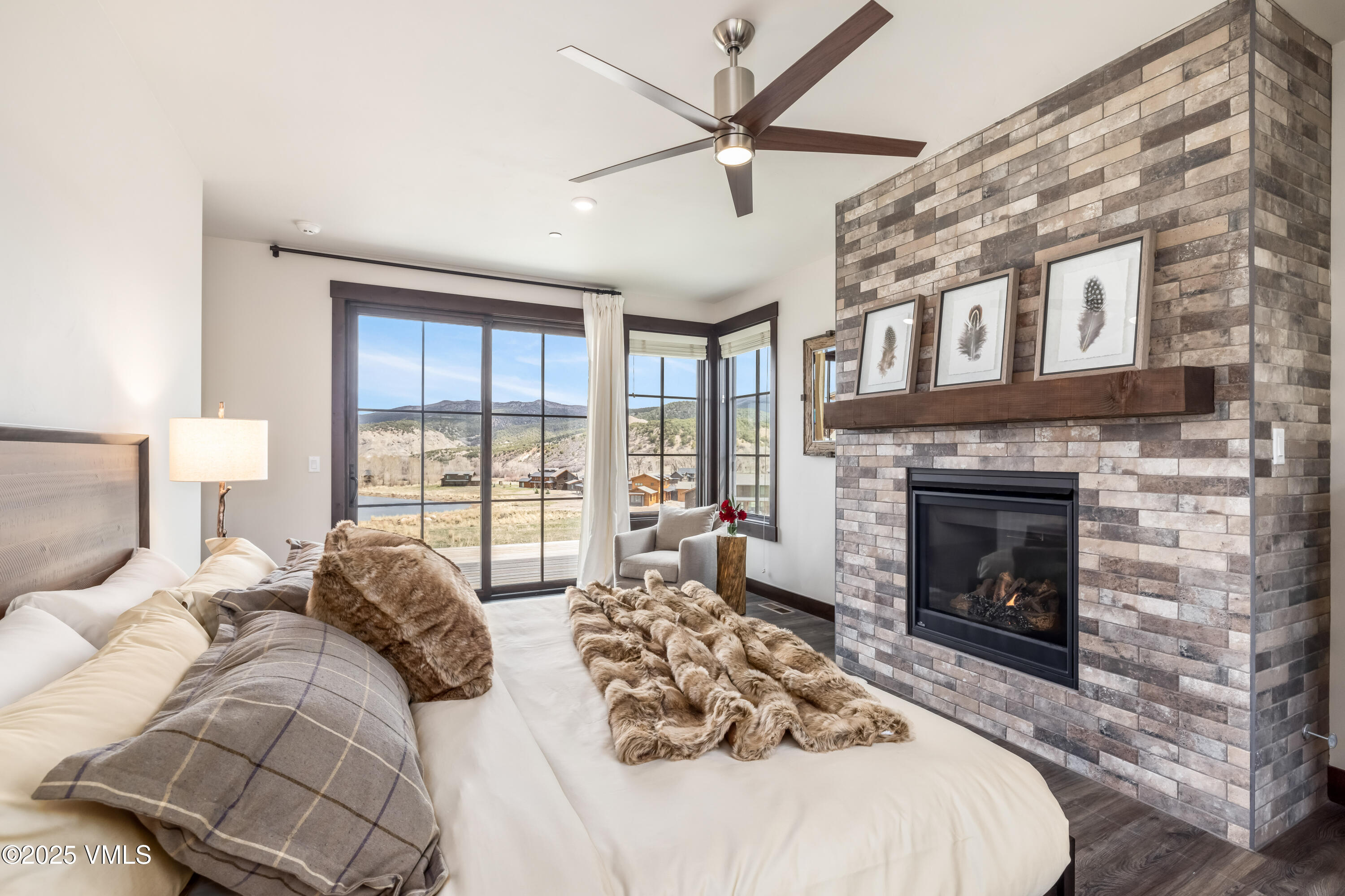 86 Hunters View Lane Eagle, CO 81631 - Photo 17 of 28 a large bedroom with a bed and a fireplace