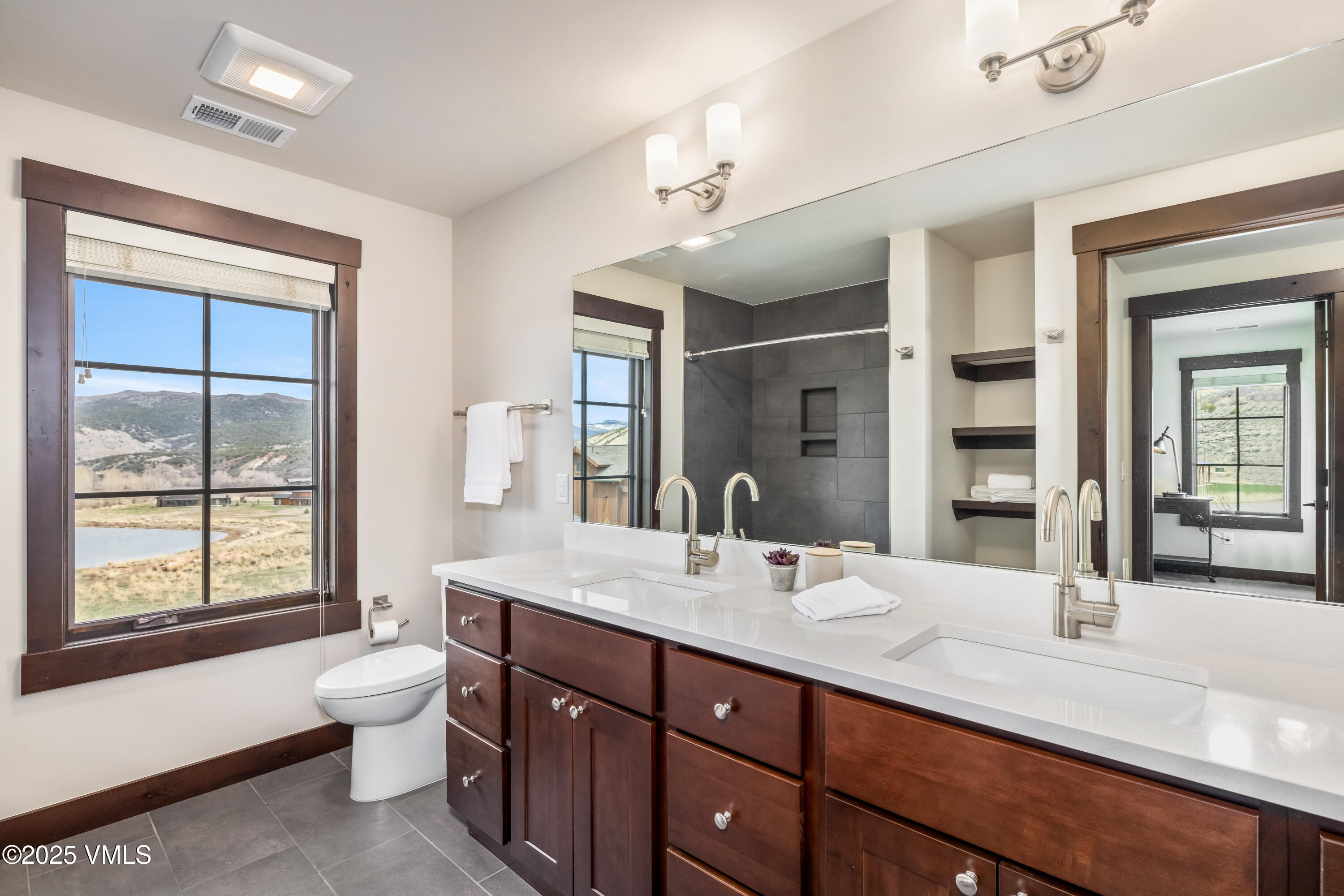86 Hunters View Lane Eagle, CO 81631 - Photo 24 of 28 a spacious bathroom with a granite countertop double vanity sink a large mirror a bathtub and window