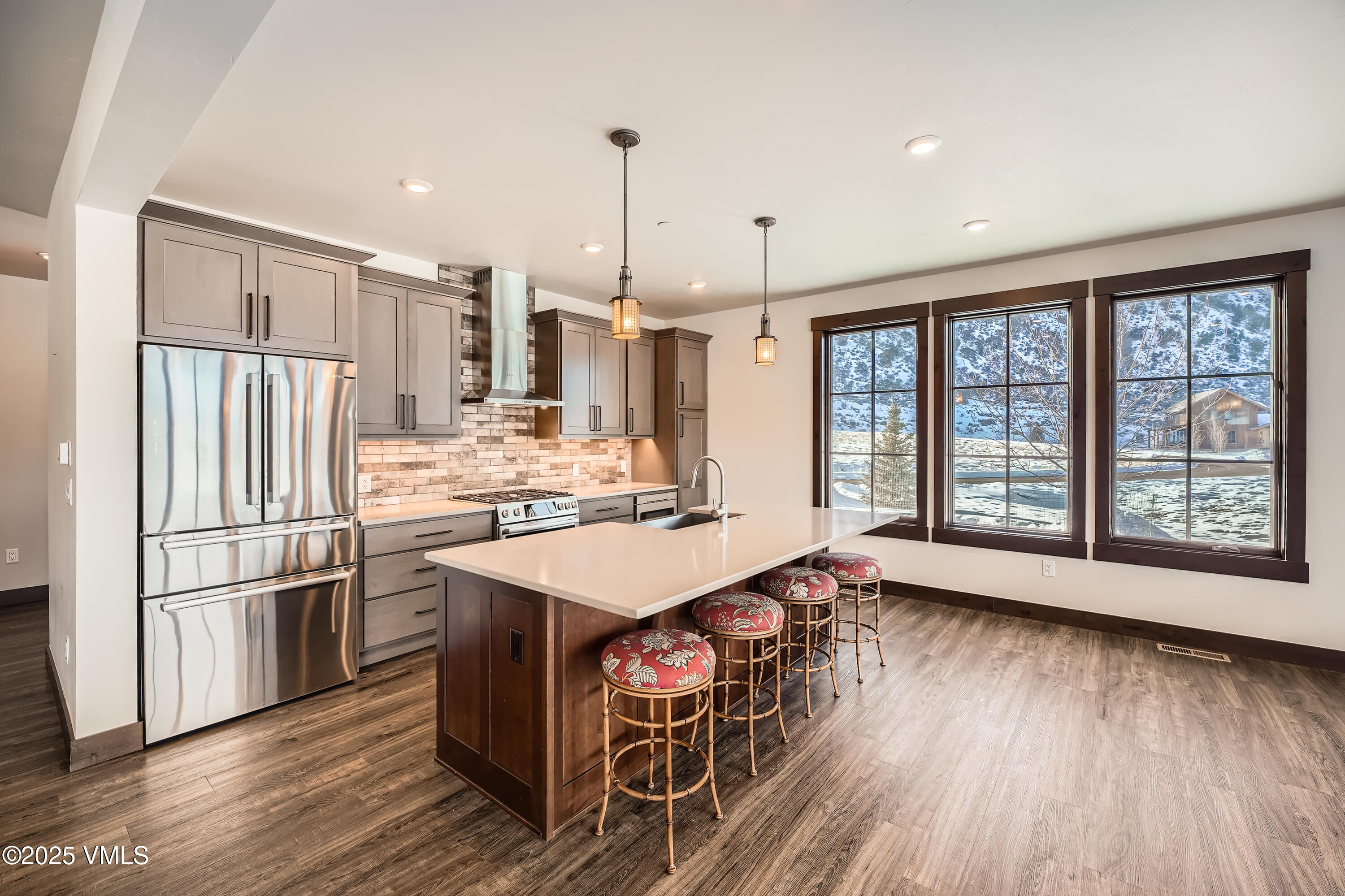 86 Hunters View Lane Eagle, CO 81631 - Photo 7 of 28 a kitchen with stainless steel appliances a stove a refrigerator and wooden floor