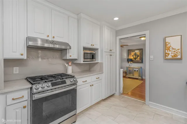 a kitchen with granite countertop a stove and a refrigerator