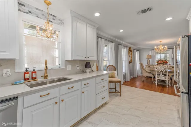 a kitchen with sink cabinets and dining table view