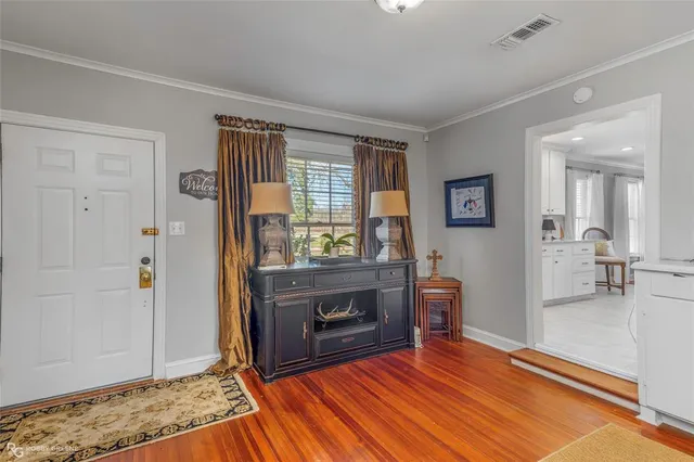 a view of living room and kitchen with wooden floor