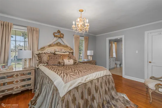 a bedroom with a bed and a chandelier