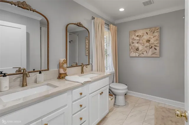 a bathroom with 2 sink and a toilet